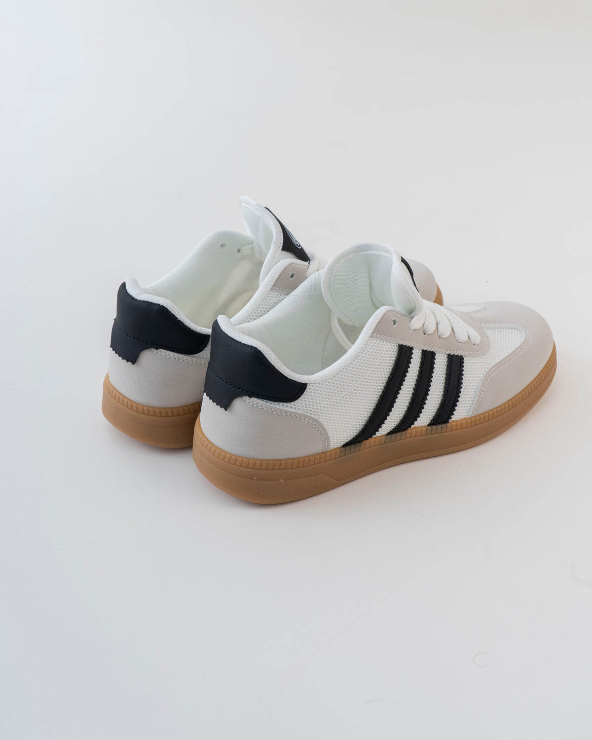 Men's white lace-up sneaker with black stripes and gum-style sole