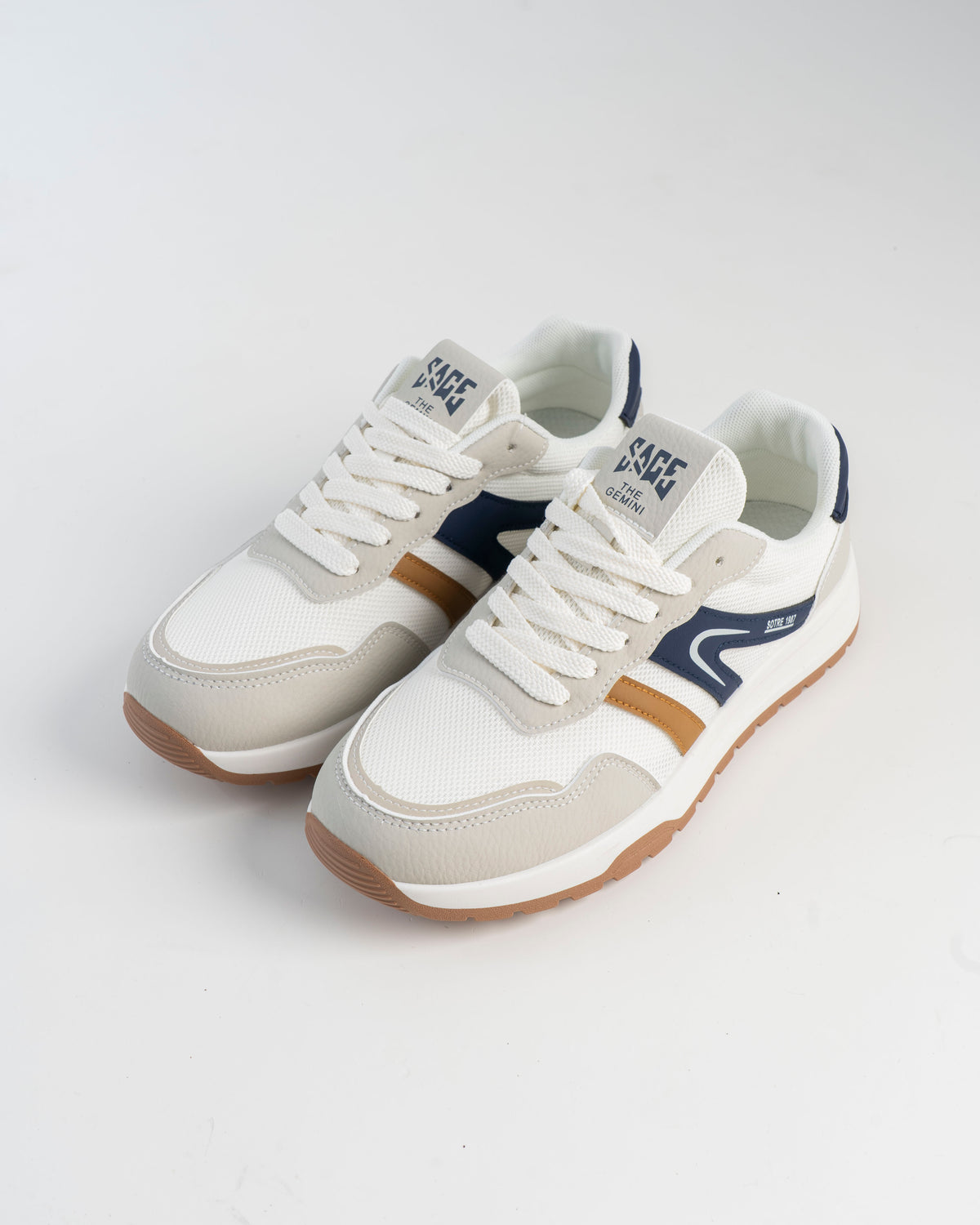 Off-white sneakers with navy and tan accents, pair view