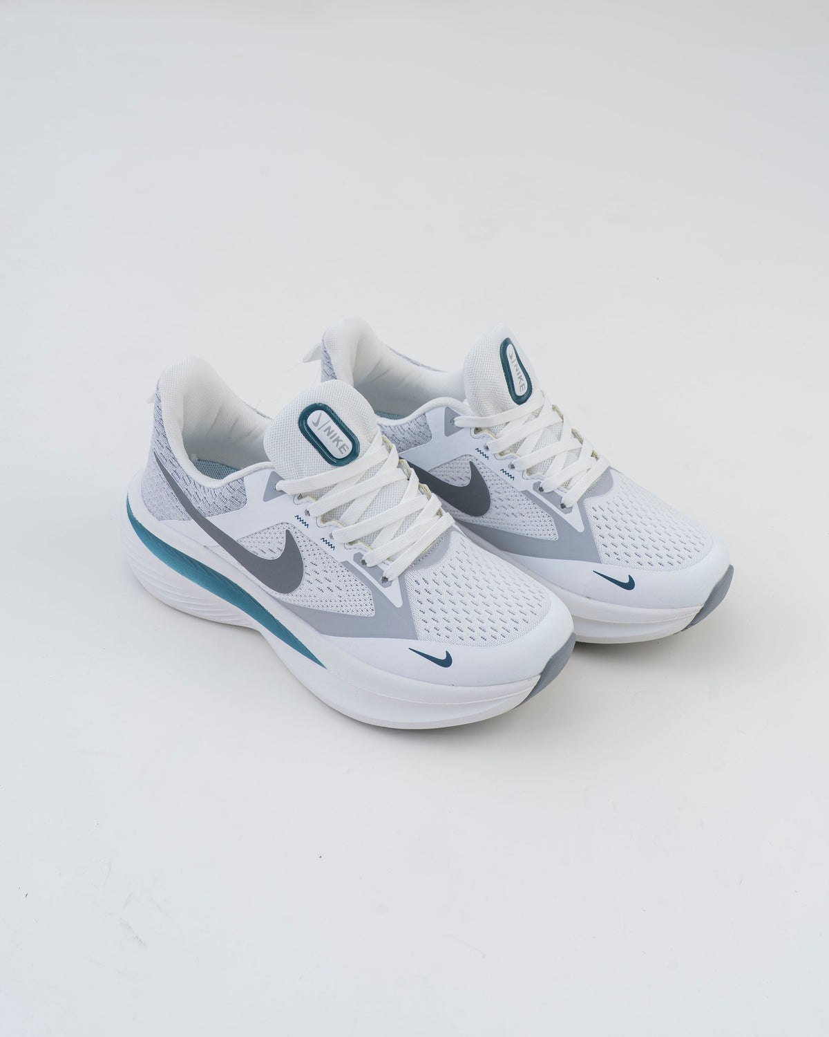 Pair of white and grey men's mesh sneakers with teal accents