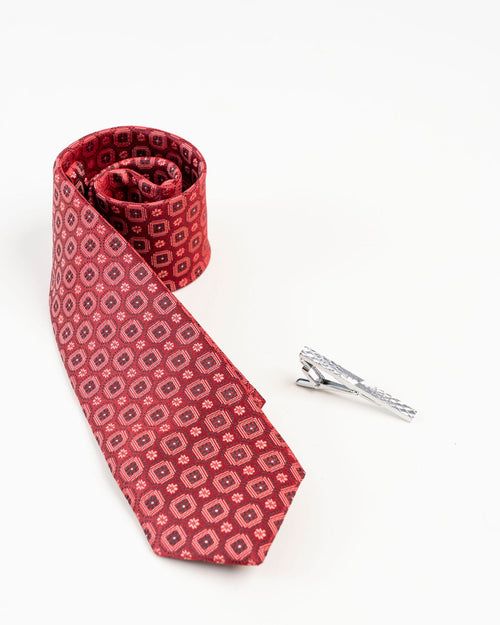 Black line gold-tone tie clip shown with a red geometric tie