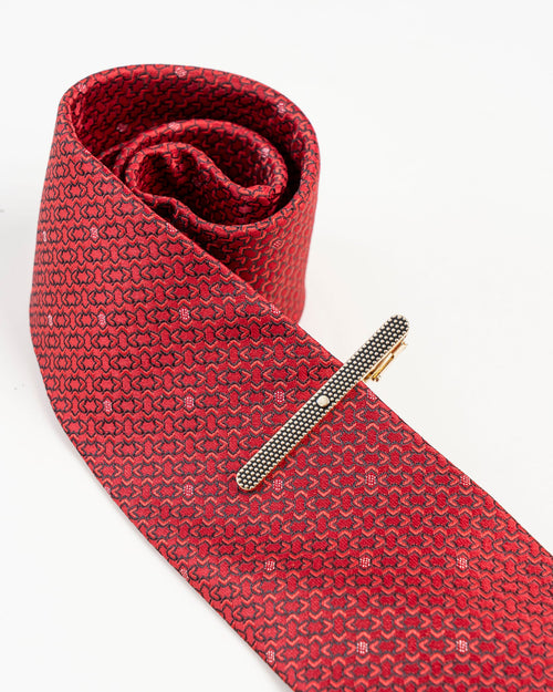 Black textured gold-tone tie clip isolated close-up